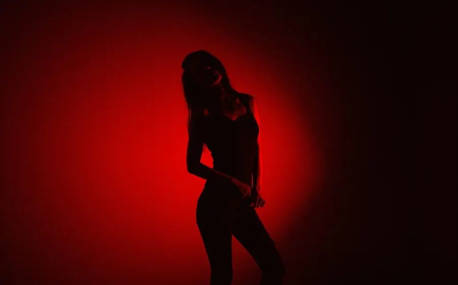 Silhouette of a woman posing in red light
